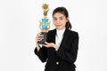 Successful young Asian business woman celebrating with trophy award over white isolated background. Success achievement in Royalty Free Stock Photo