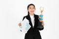 Successful young Asian business woman celebrating with trophy award over white isolated background. Success achievement in Royalty Free Stock Photo