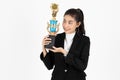 Successful young Asian business woman celebrating with trophy award over white isolated background. Success achievement in Royalty Free Stock Photo