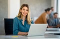 Successful young attractive businesswoman working on laptop in her workstation at office Royalty Free Stock Photo