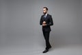 Successful young bearded business man in classic black suit shirt tie posing isolated on grey background studio portrait Royalty Free Stock Photo