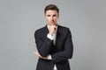 Successful young business man in classic black suit shirt posing isolated on grey background studio portrait Royalty Free Stock Photo