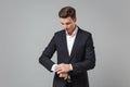 Successful young business man in classic black suit shirt posing isolated on grey background studio portrait Royalty Free Stock Photo