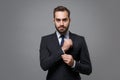 Successful young business man in classic black suit shirt tie posing isolated on grey background studio portrait Royalty Free Stock Photo