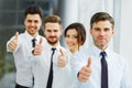 Successful young business people showing thumbs up Royalty Free Stock Photo