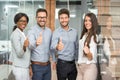 Successful young business people showing thumbs up sign Royalty Free Stock Photo