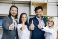 Successful young business people showing thumbs up sign Royalty Free Stock Photo