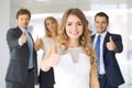 Successful young business people showing thumbs up sign Royalty Free Stock Photo