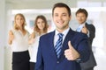 Successful young business people showing thumbs up sign Royalty Free Stock Photo