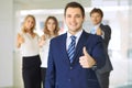 Successful young business people showing thumbs up sign Royalty Free Stock Photo