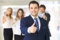 Successful young business people showing thumbs up sign Royalty Free Stock Photo