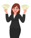 Successful young business woman showing/holding cash, money, dollar, currency or banknotes in hands. Modern lifestyle, business. Royalty Free Stock Photo