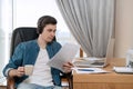 Successful young businessman in his home office with cup of coffee Royalty Free Stock Photo