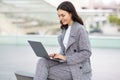 Successful young caucasian businesswoman websurfing on laptop device outdoors Royalty Free Stock Photo