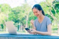 Successful young girl is a university student with cup of coffee and a phone in her hands working on a laptop at the table Royalty Free Stock Photo