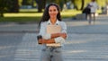 Successful young latin business woman girl student stylish lady stands in city street crosswalk road traffic car