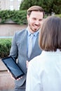 Handsome young male and female business people talking in front of an office building Royalty Free Stock Photo