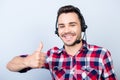 Successful young man operator of a telemarketing is smiling, wearing a headset. He is isolated on a pure light Royalty Free Stock Photo