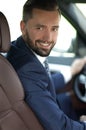 Handsome young man sitting in the front seat of a car looking at the camera Royalty Free Stock Photo