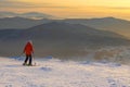 Successful young man skiing in the mountains Sheregesh. Skier resting on mountain top. Caucasian Skier on a background of sky . Royalty Free Stock Photo