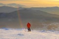 Successful young man skiing in the mountains Sheregesh. Skier resting on mountain top. Caucasian Skier on a background of sky . Royalty Free Stock Photo