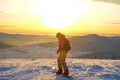 Successful young man snowboarding in the mountains Sheregesh. Snowboarder resting on mountain top. Caucasian snowboarder on a Royalty Free Stock Photo