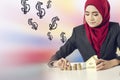 Successful young muslimah saving money for her dream house over abstract double exposure background Royalty Free Stock Photo