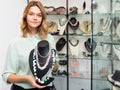 Saleswoman demonstrating pearl beads