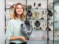 Saleswoman demonstrating pearl beads Royalty Free Stock Photo