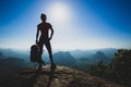 hiker stand on sunrise mountain peak cliff edge