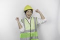 A successful young woman labor is wearing safety helmet and vest, isolated by white background.