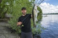 Successful zander fishing. Happy fisherman with big walleye fish trophy at lake Royalty Free Stock Photo