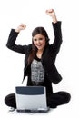 Successfull young woman by the computer on the flo