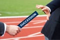 Succession - Businessman hands over baton in stadium at relay race Royalty Free Stock Photo