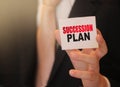 Succession Plan words on a card in hand of businessman. Business profit and success concept Royalty Free Stock Photo