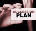 Succession Plan words on a card in hand of businessman. Business profit and success concept Royalty Free Stock Photo