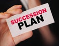 Succession Plan words on a card in hand of businessman. Business profit and success concept Royalty Free Stock Photo