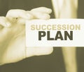 Succession Plan words on a card in hand of businessman. Business profit and success concept Royalty Free Stock Photo