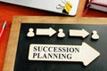 Succession planning concept. Wooden figures and arrows Royalty Free Stock Photo