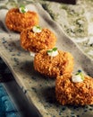 Succulent array of deliciously cooked Manchego Cheese Croquettes on a long tray