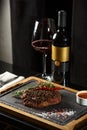 Succulent grilled beef steak with red wine, seasonings, fresh rosemary and grilled vegetables on cutting board Royalty Free Stock Photo