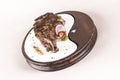 Succulent grilled large t-bone steak garnished with herbs, radish and salt, on a white plate, brown background