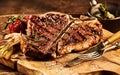 Succulent grilled t bone steak with fork and knife
