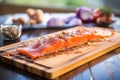 succulent smoked salmon on cedar plank on kitchen table