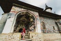 Parishioner at the doors of Sucevita painted fortified Monastery, Romania Royalty Free Stock Photo