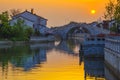 Sunset over the flowing water of a small bridge in Suzhou. Royalty Free Stock Photo