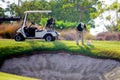 Sucina, Spain - August 08 2018: A groundsman on a golf course, taking soil samples from the fairway near a bunker with an augur. Royalty Free Stock Photo