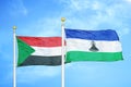 Sudan and Lesotho two flags on flagpoles and blue sky