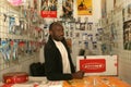 A Sudanese refugee in his mobile phone shop