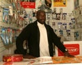 A Sudanese refugee in his mobile phone shop